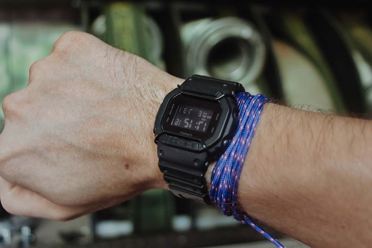 human person wearing black digital watch wristwatch