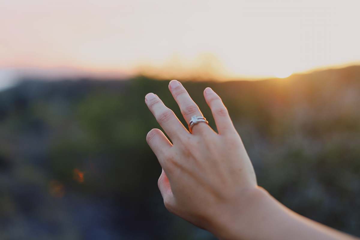 human person wearing gold-colored ring finger