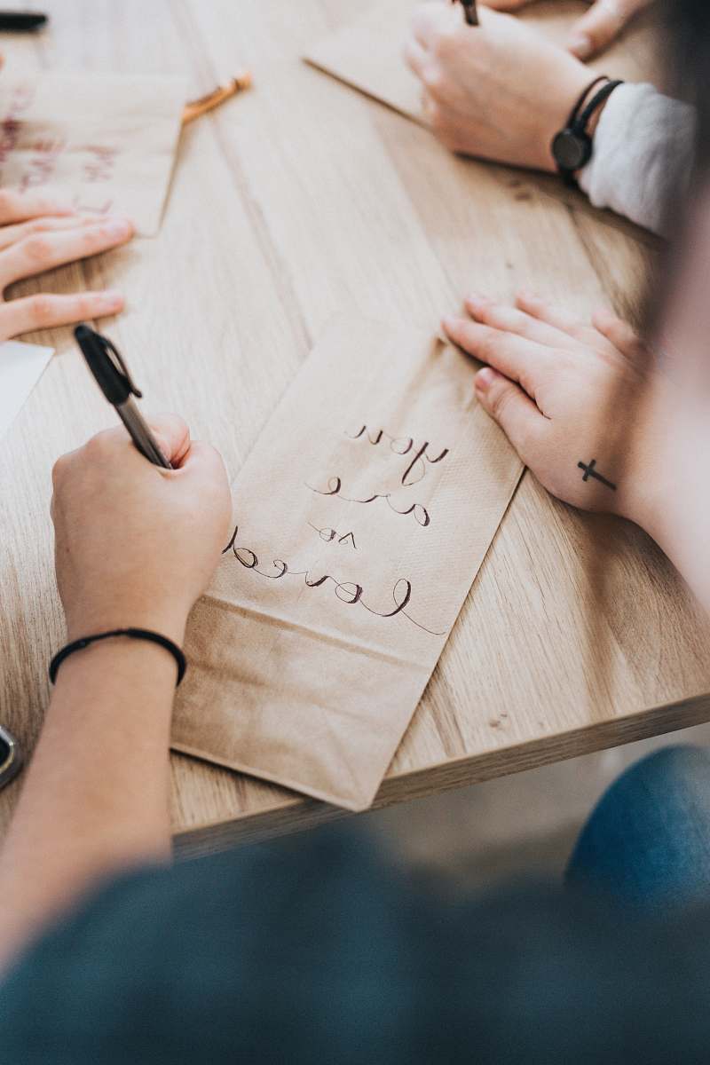 human person writing on brown paper people
