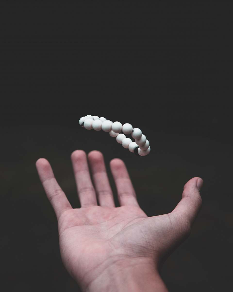 human shallow focus photo of beaded white bracelet people