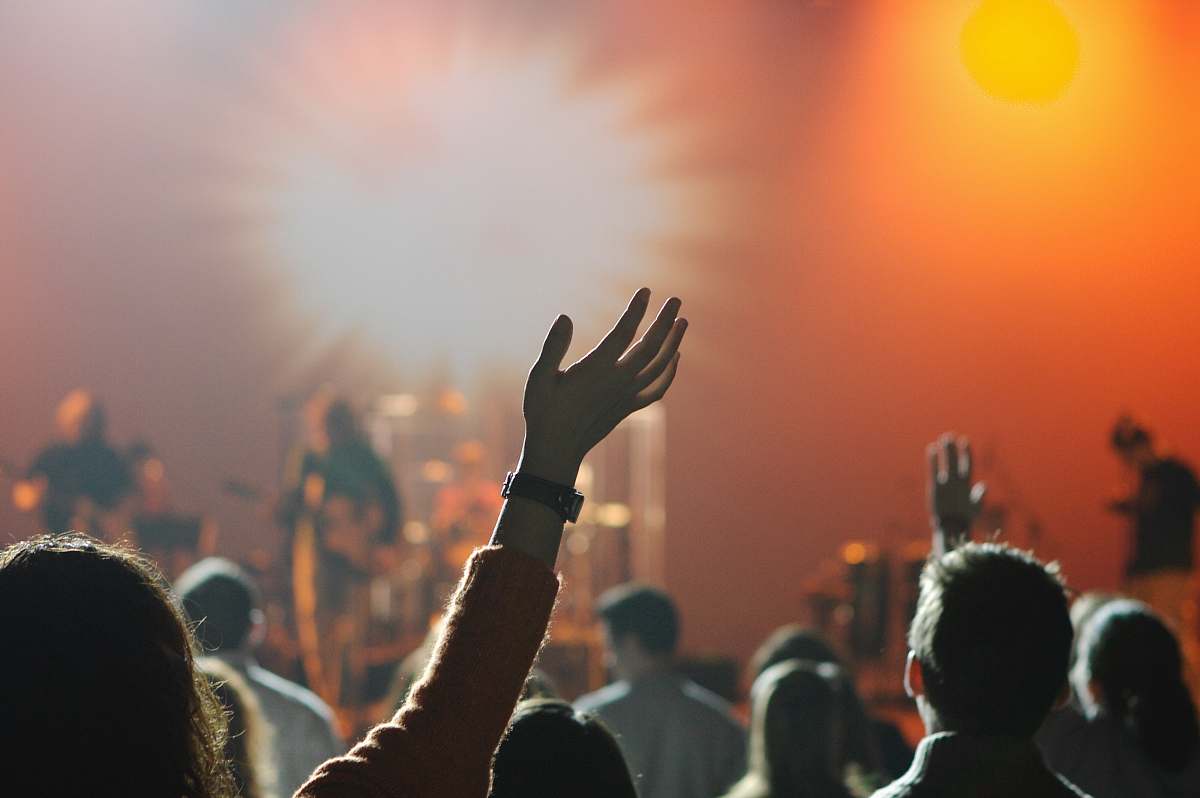 people shallow focus photography of hand and people music