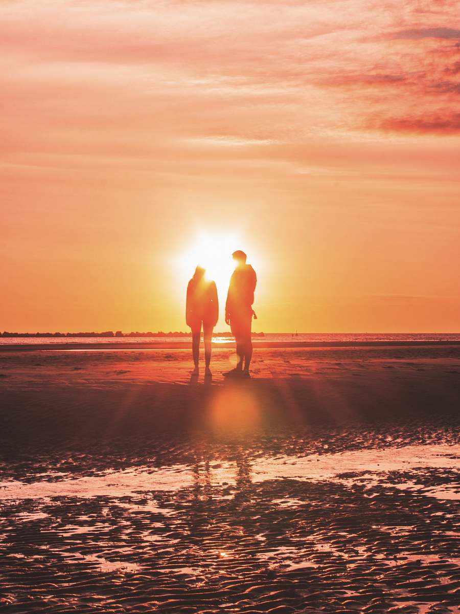 human two persons stands near shore nature