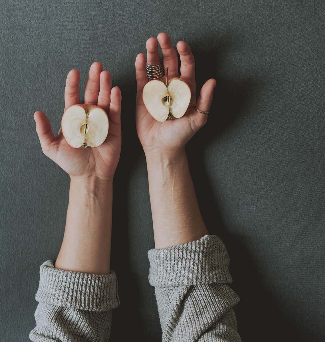 human unknown person holding sliced apples finger