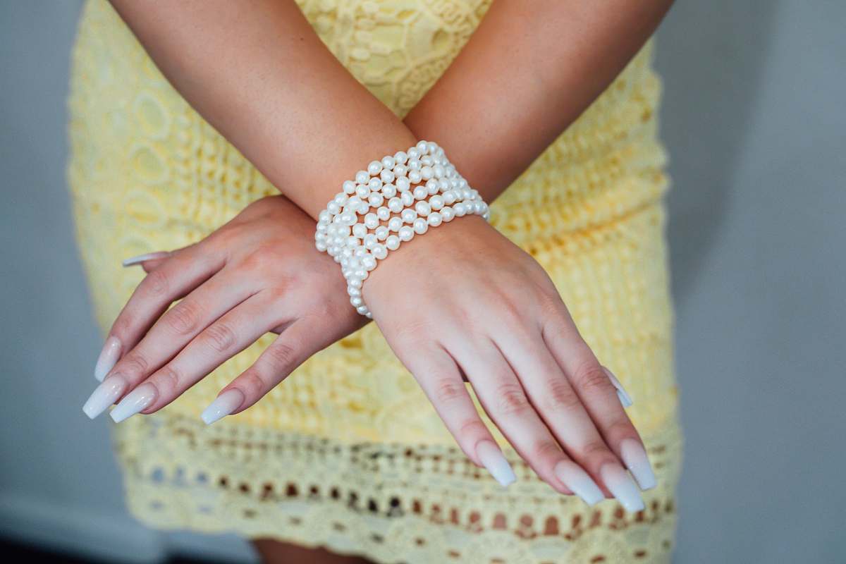 human white beaded bracelet hand