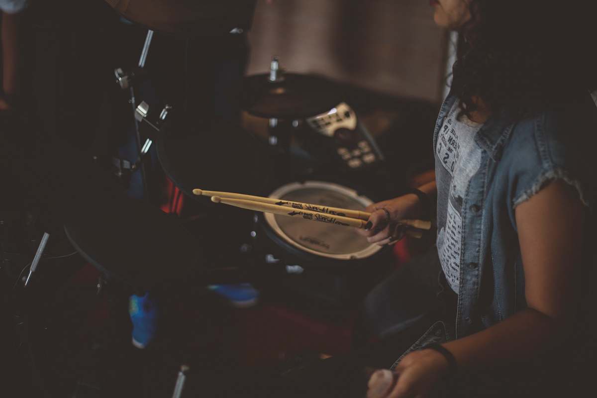 human woman carrying drums sticks people