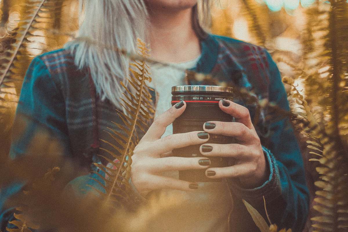 human woman holding black and gray mug girl