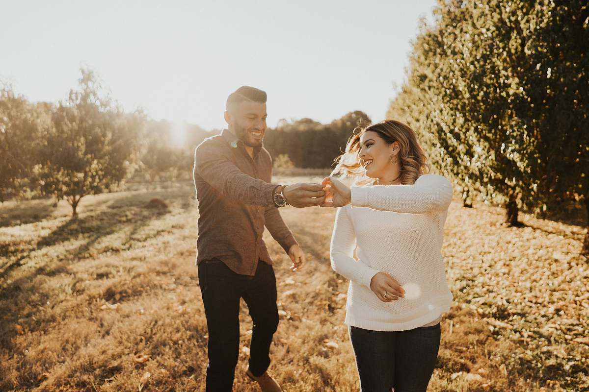 human woman holding hands with man during daytime apparel
