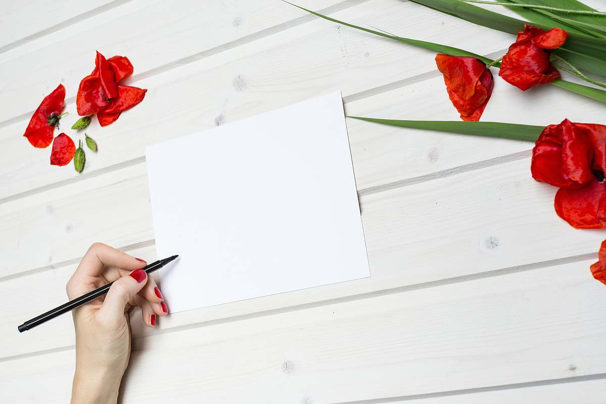 people woman holding pen beside blank paper human