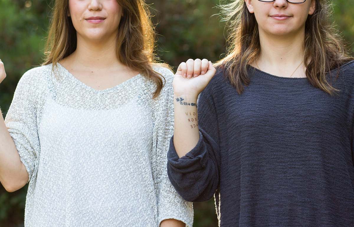 human woman showing her wrist with tattoo people