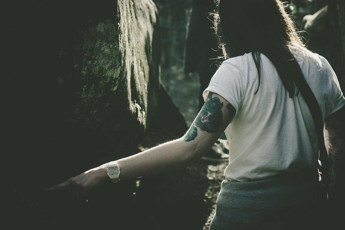 human woman standing in front of tree tattoo