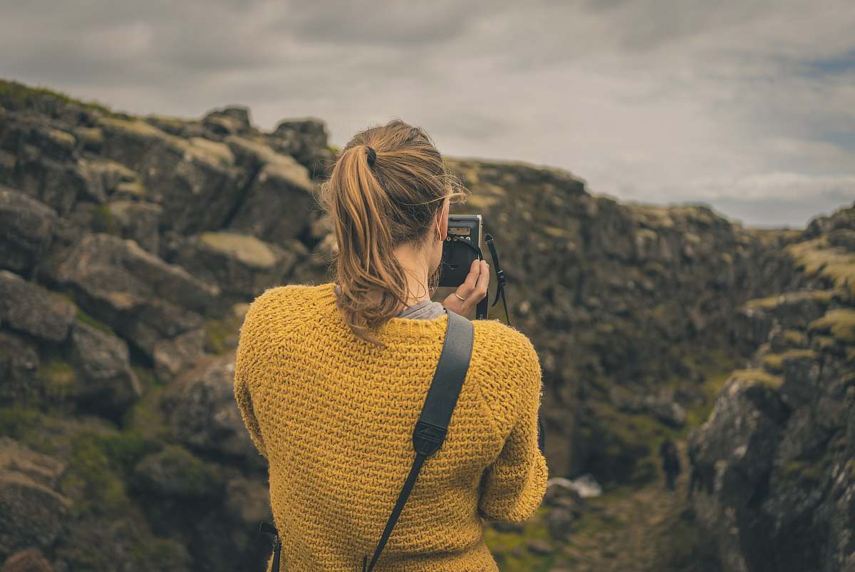 people woman taking picture of mountain girl
