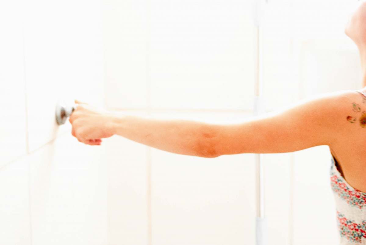 human woman touching door knob arm