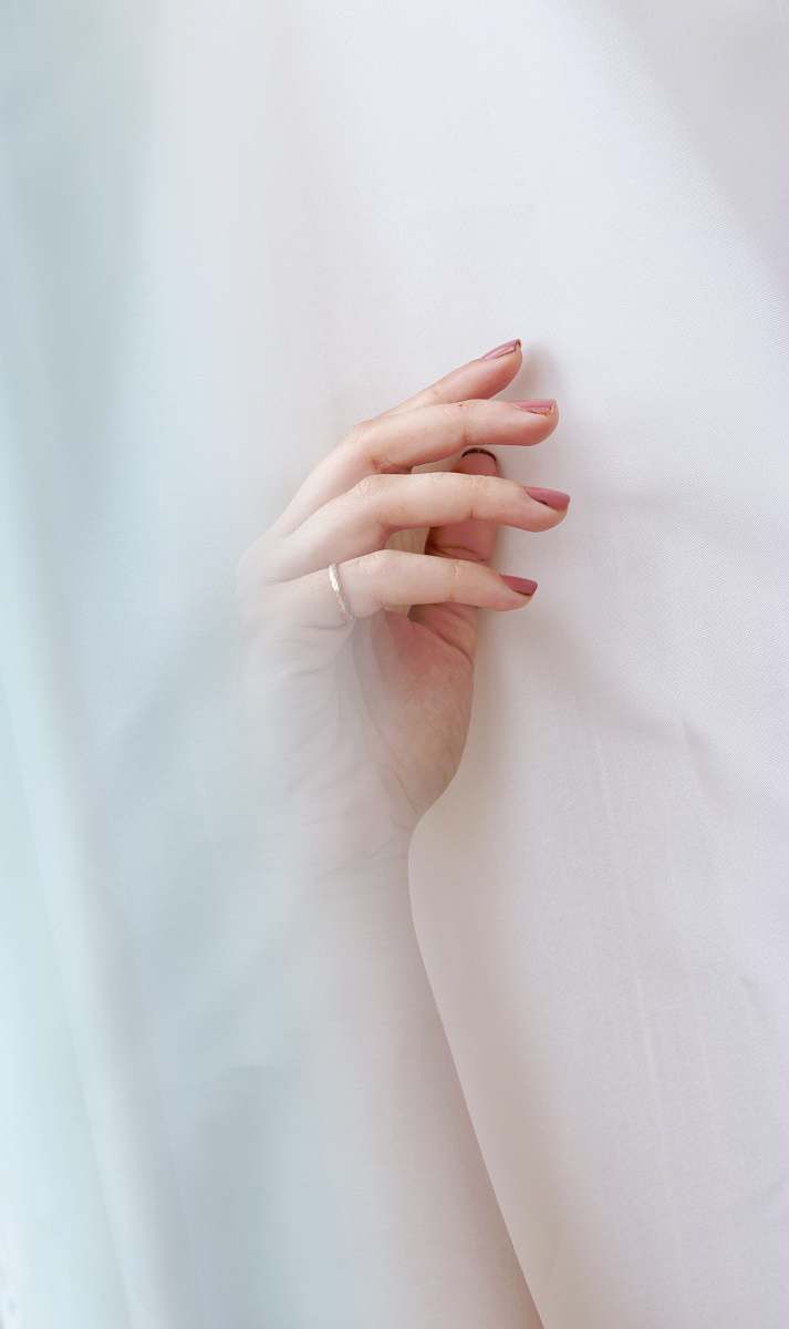 hand woman wearing gold-colored ring finger