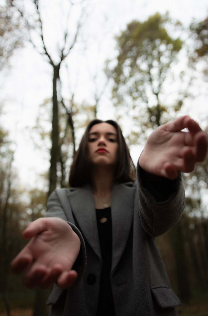 human woman wearing gray blazer finger