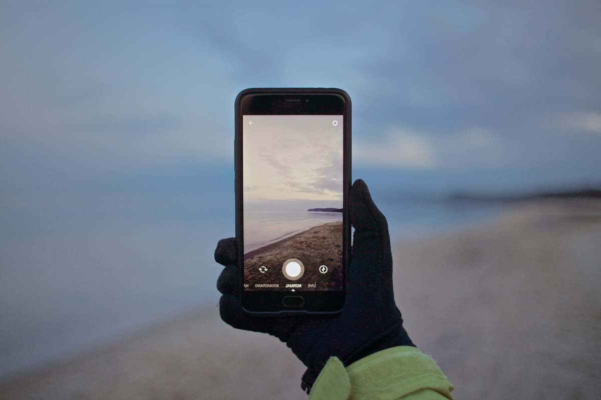 iphone person black smartphone taking picture glove