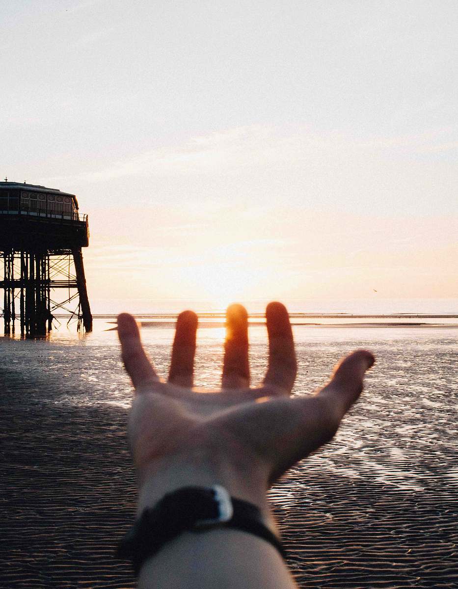 dock person showing left hand near body of water blackpool