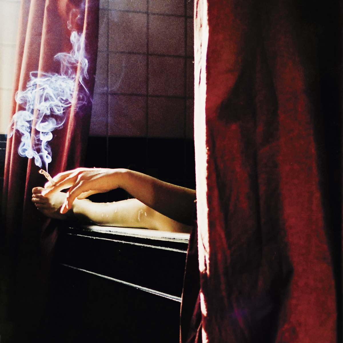 woman person holding cigarette near window bathtub