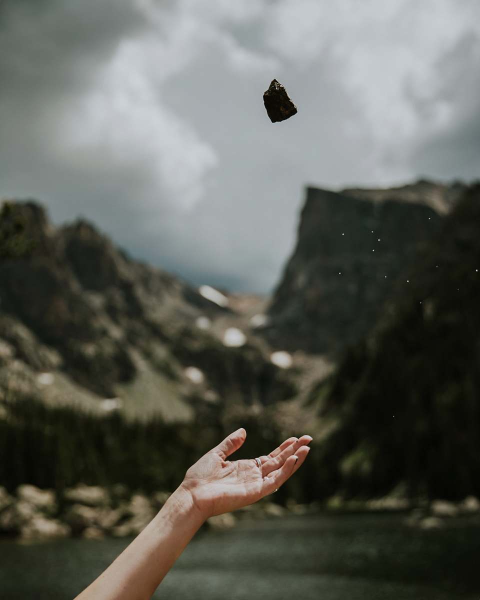 Capture the essence of playful energy with this vibrant image of a woman joyfully throwing stones into the air under a clear blue sky. Perfect for illustrating themes of freedom, outdoor adventure, or carefree moments, this scene conveys a sense of spontaneity and joy. Ideal for use in articles, blog posts, or marketing materials that celebrate nature, recreation, and the spirit of play.