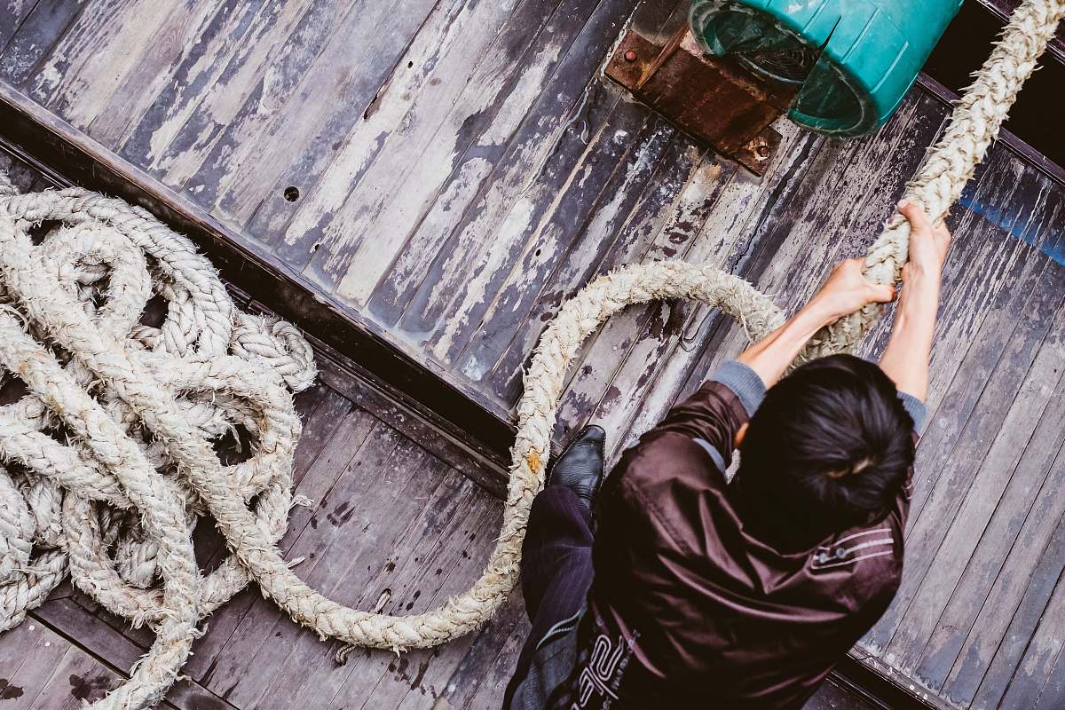 pulling man pulling gray rope strength