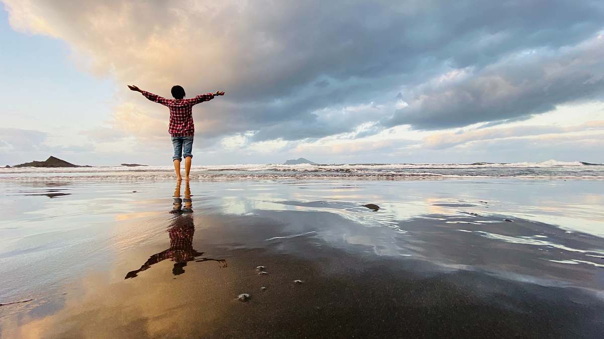 water person standing on shore outdoors
