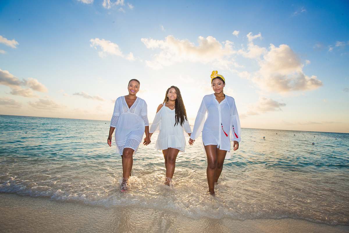 ocean three women holding hands in seashore beach