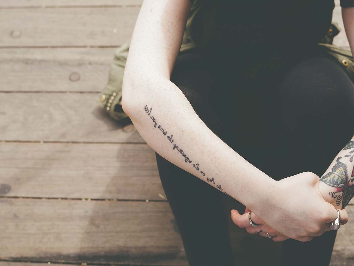 hand human hand with black tattoes arm