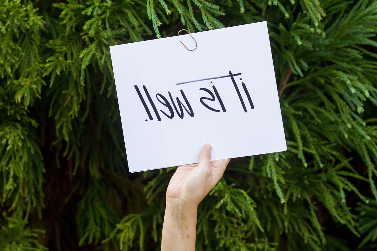 sign person holding white paper with it is well text message