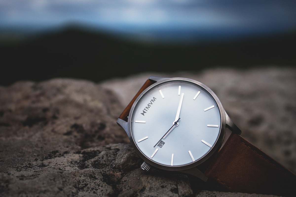 face round silver-colored analog watch with black leather strap time