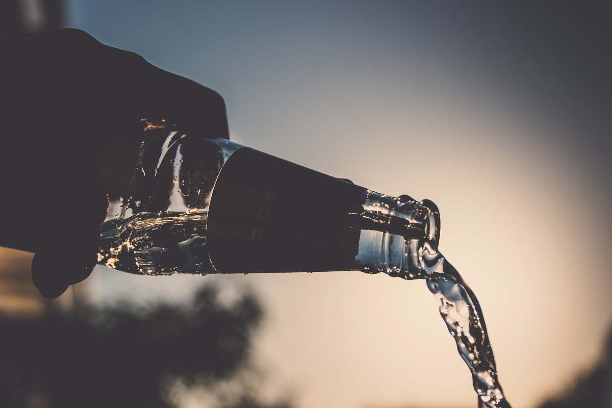 waterflow person pours water bottle bottle