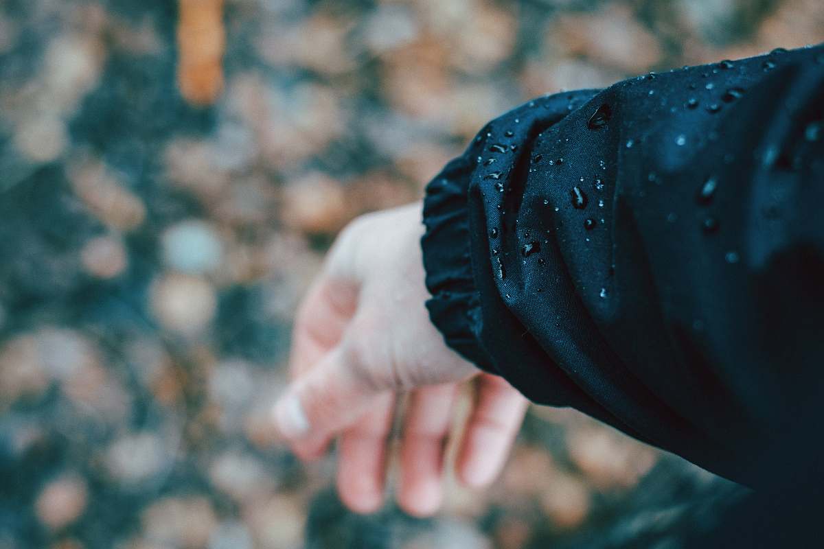 sleeve person wearing black jacket arm