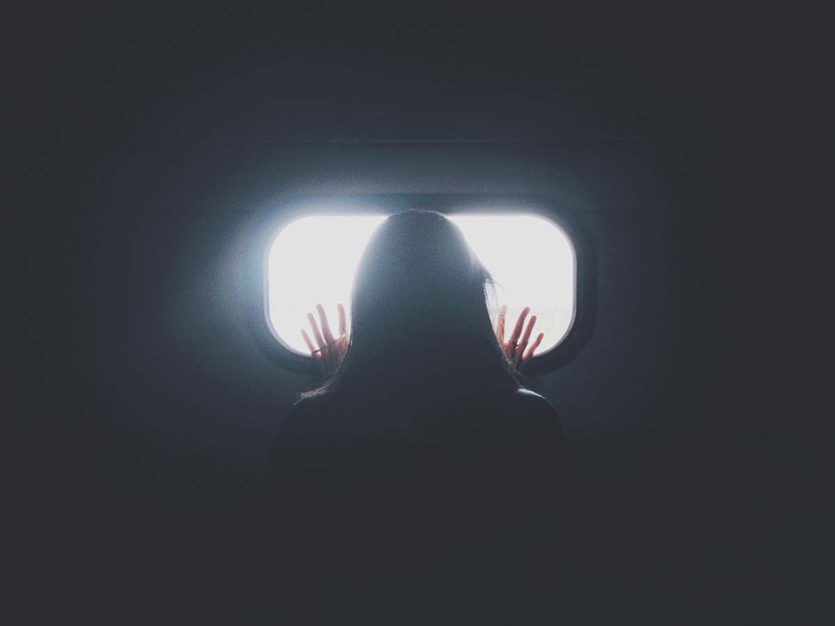 window woman stand in front of glass mirror grey