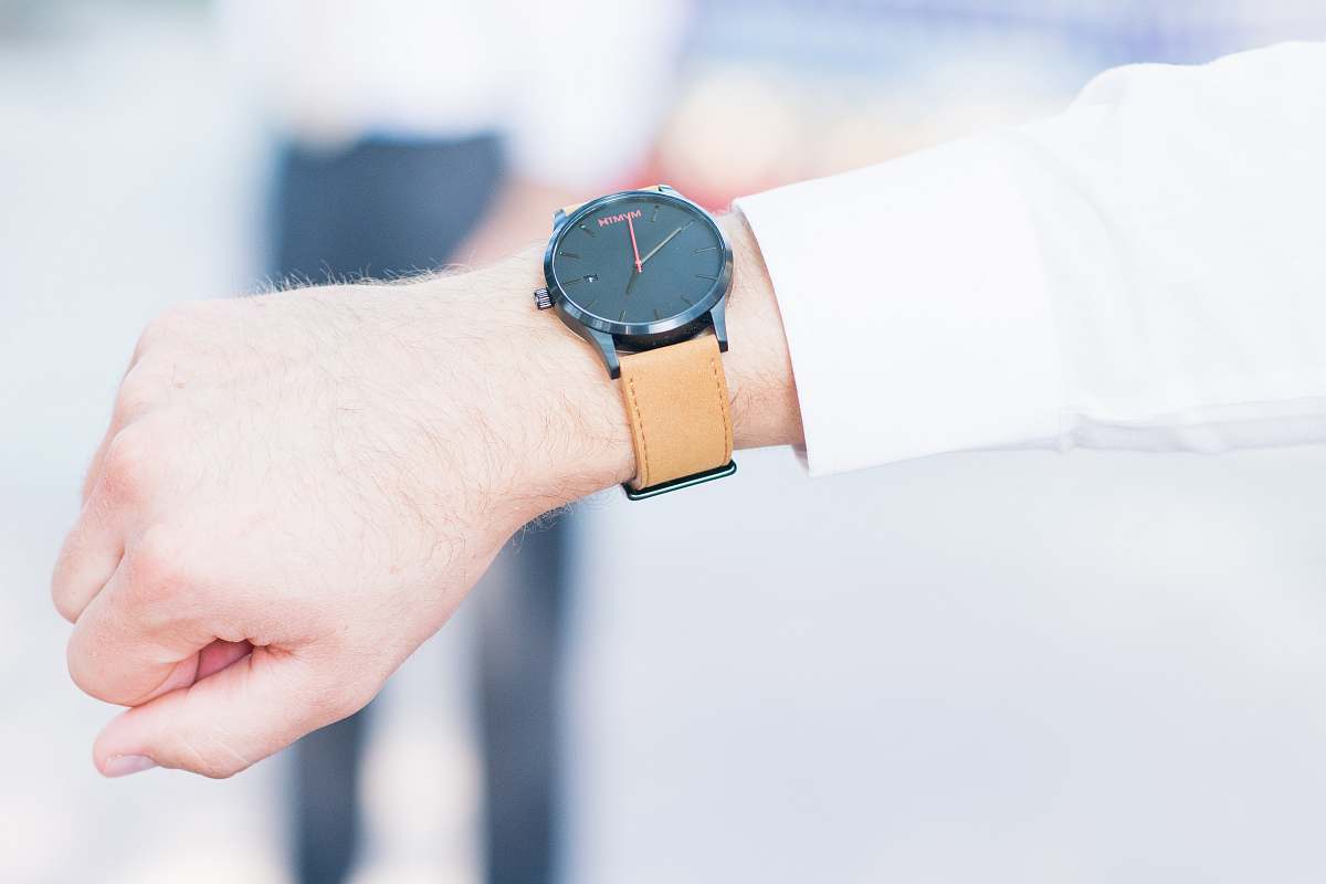 human person using watch displaying 10:00 time person