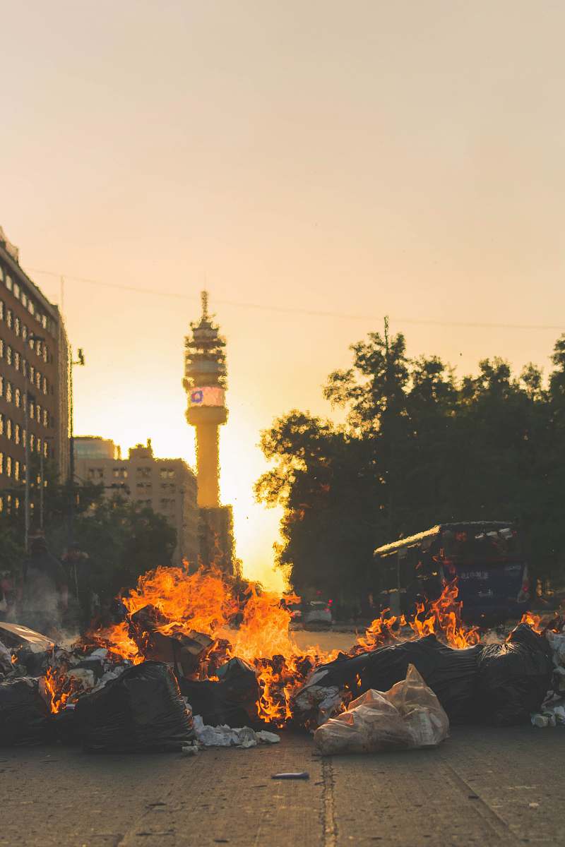 flame burned textiles on road bonfire