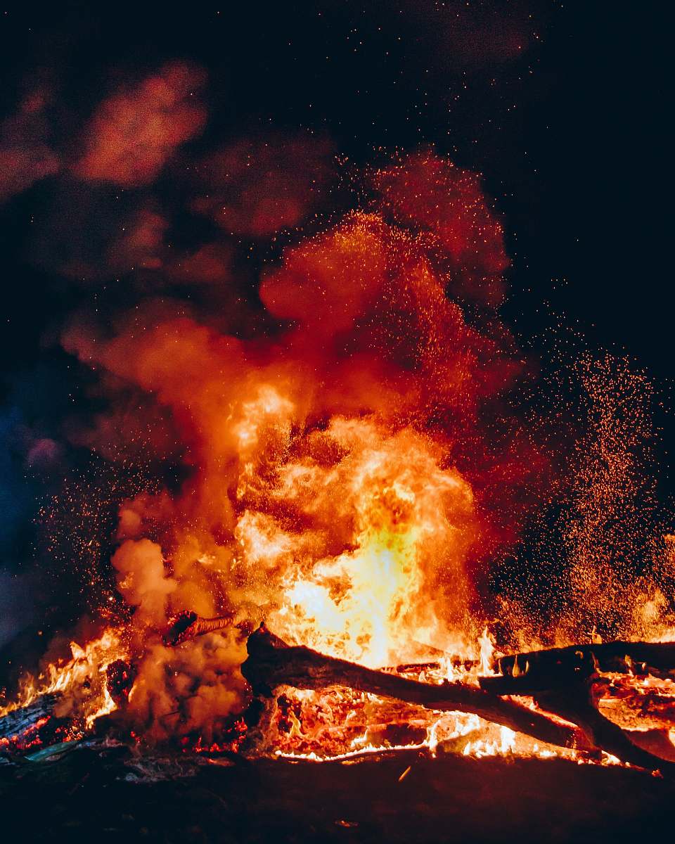 person fire with black smoke during night human