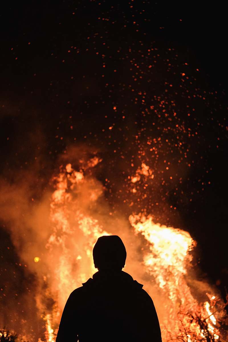 person person standing in front of fire human