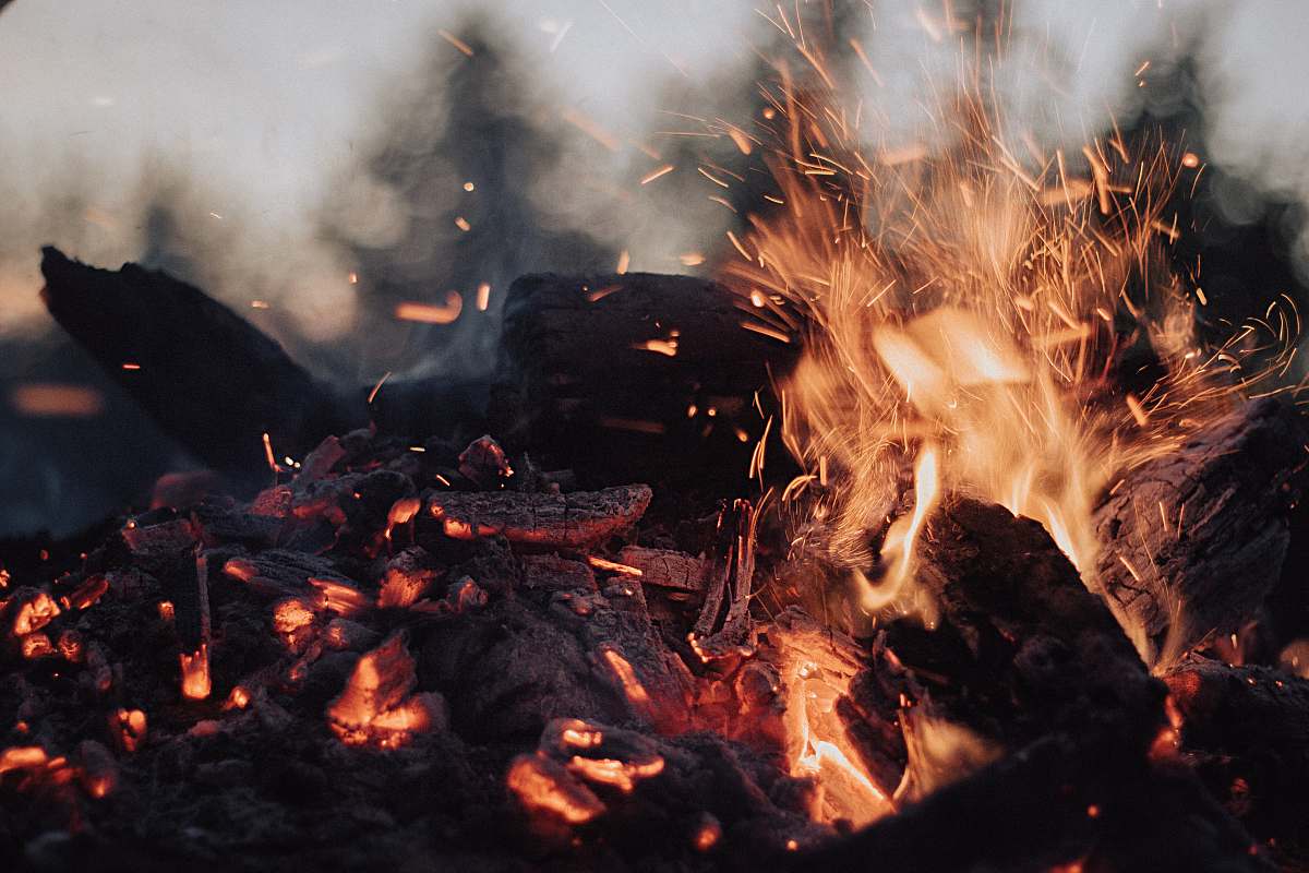 person tilt-shift lens photography of fire ember human