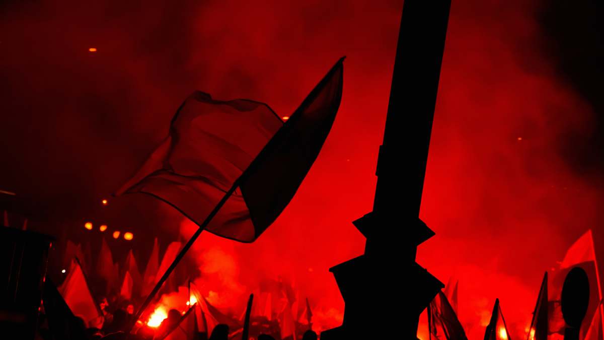poland people raising flags near bonfire red