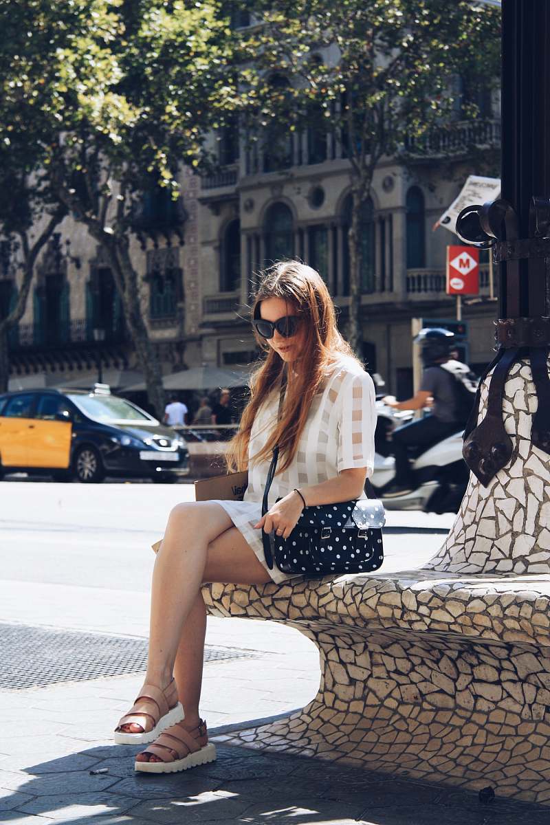 accessory woman in sunglasses sitting on concrete post sunglasses