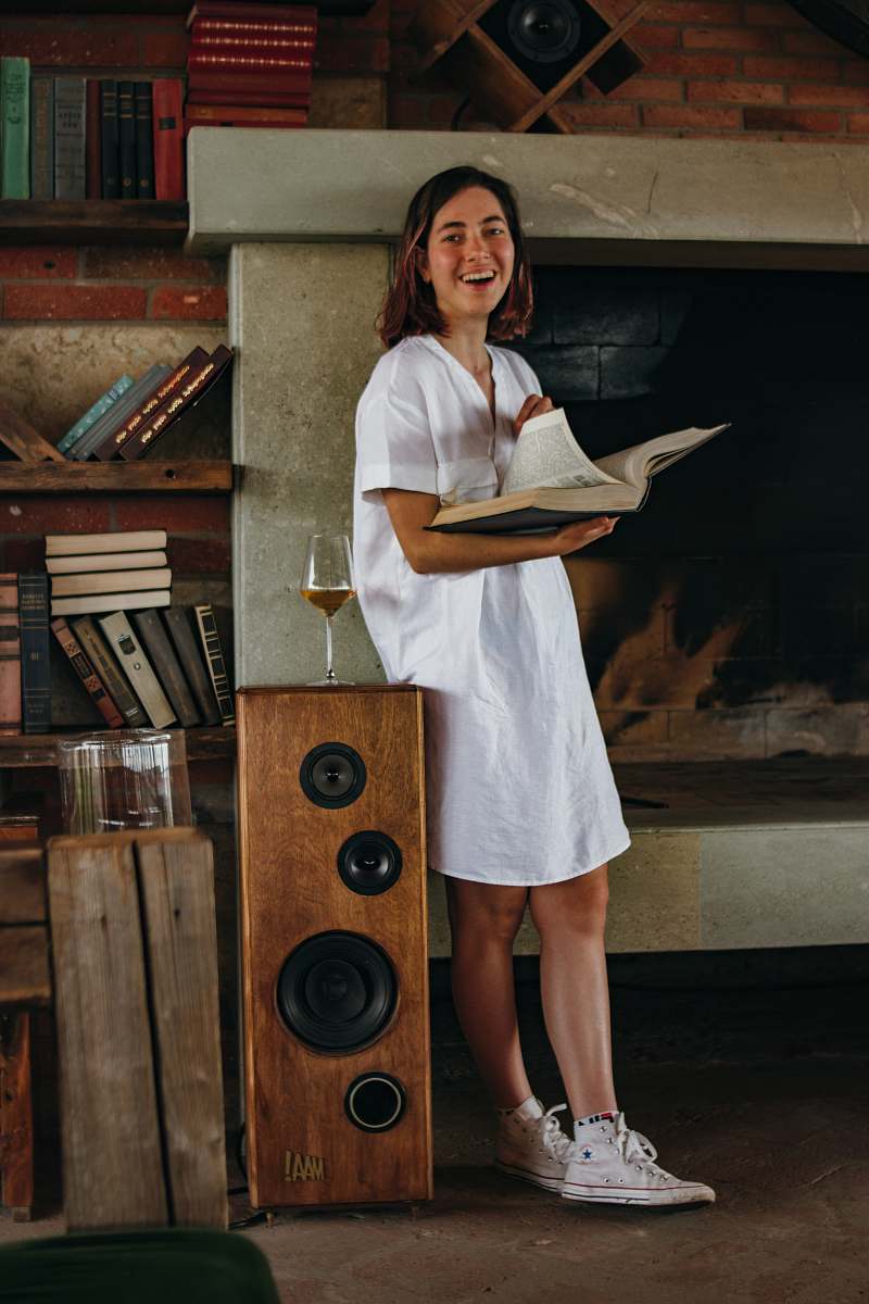clothing laughing woman standing and holding open book footwear