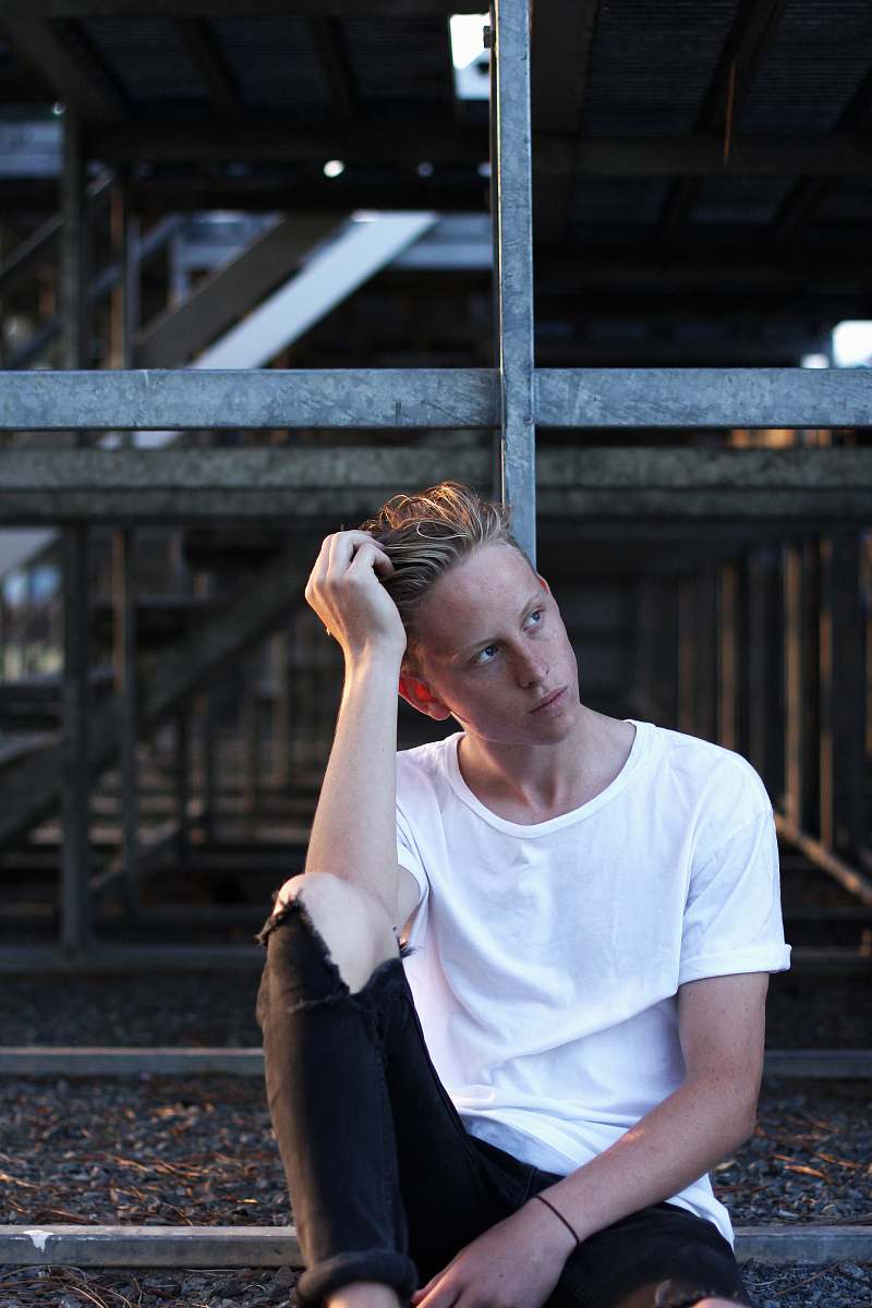 clothing man sitting on floor wearing white crew-neck T-shirt human
