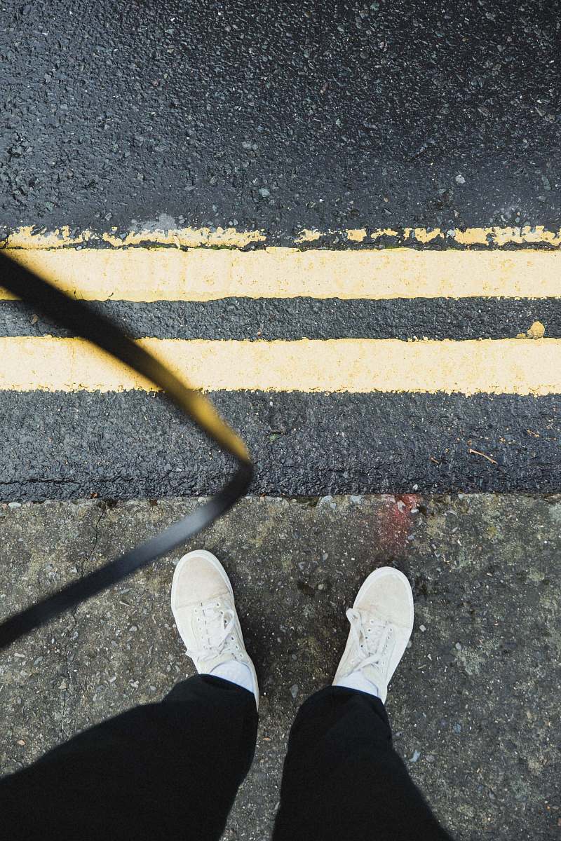 asphalt person in black pants tarmac