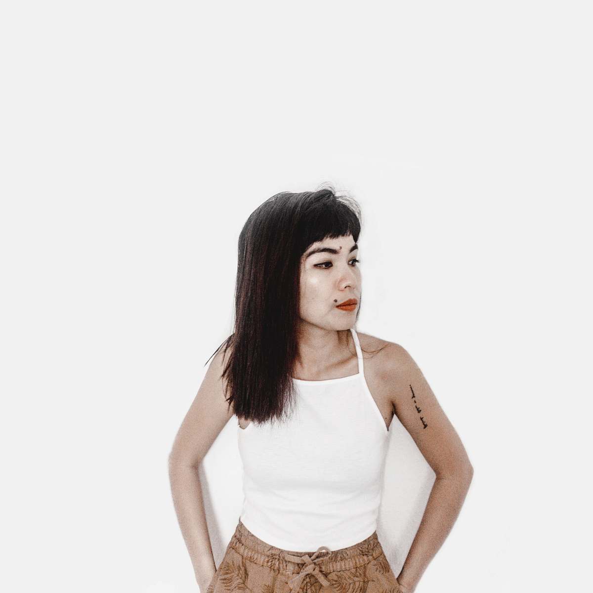 clothing woman wearing white spaghetti-strap shirt shorts