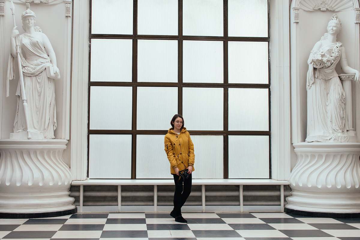 clothing woman wearing yellow hooded jacket and black pants human