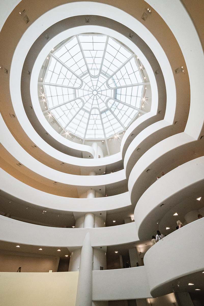 building low-angle photography of white building staircase
