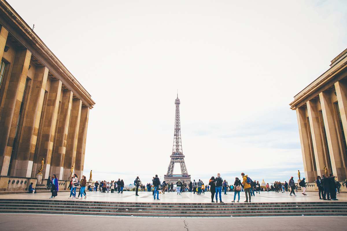 tower people standing while watching Eiffel tower paris