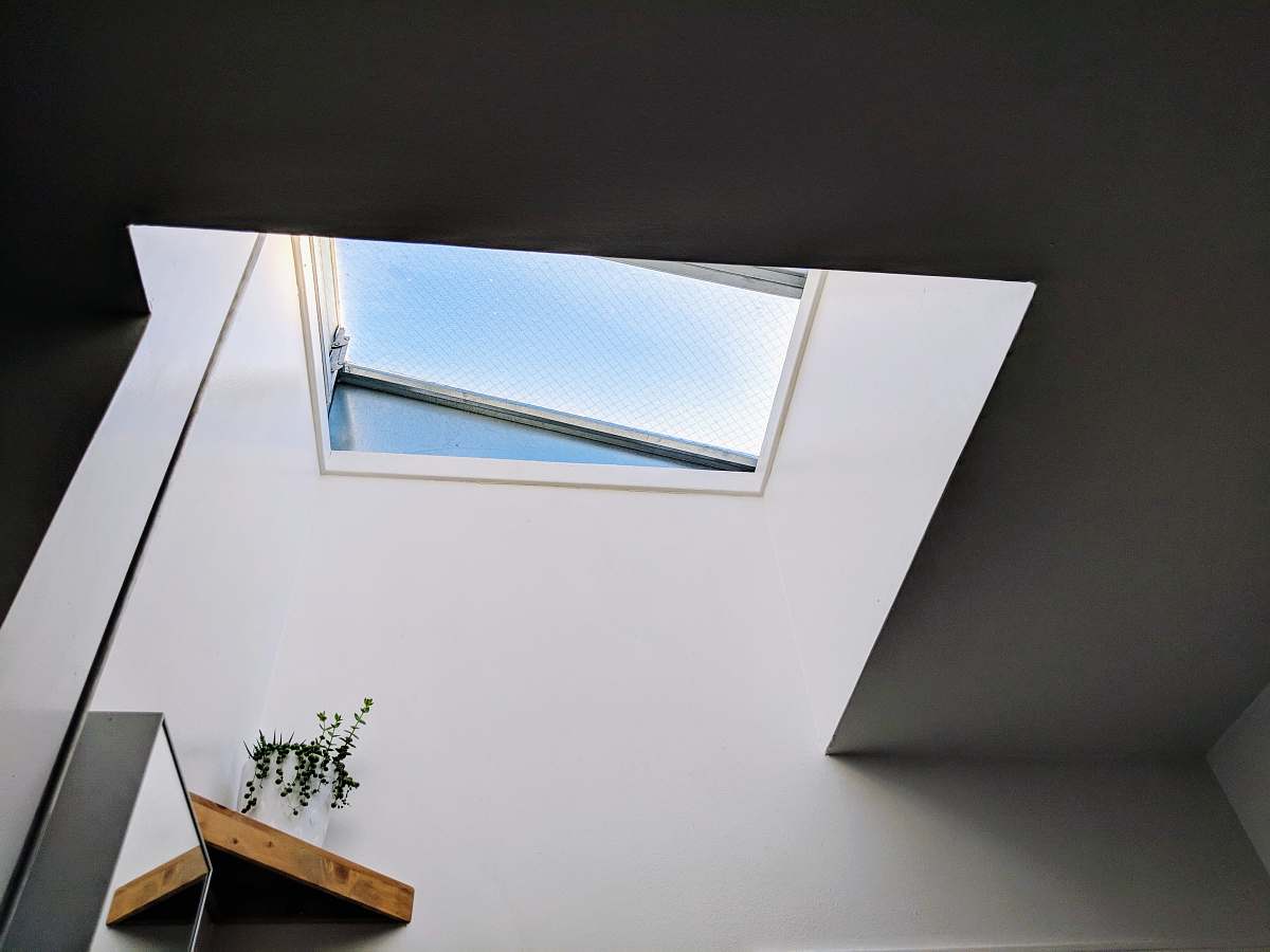 window photo of white wall paint skylight