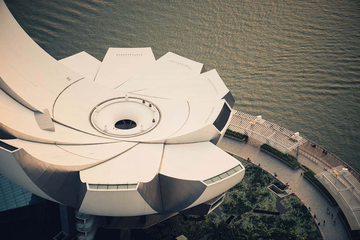 water white and gray building near body of water in aerial photographty building