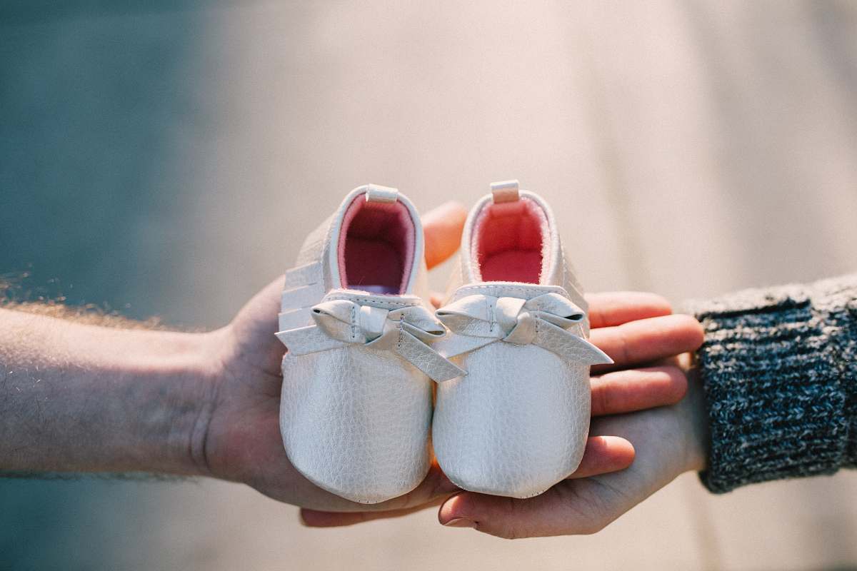 Clothing Two Person Holding Pair Of Baby's Shoes Shoe Image Free Photo