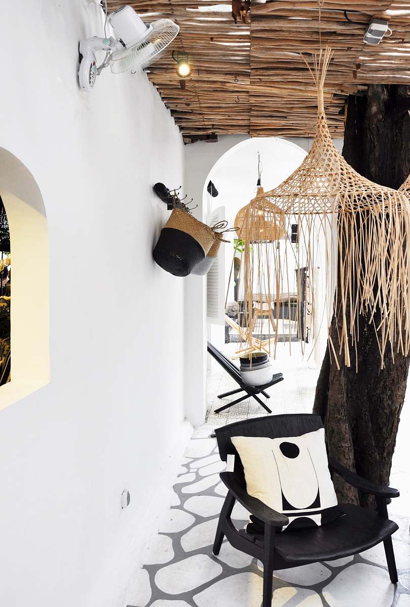 indonesia black wooden armchair with white throw pillow interior