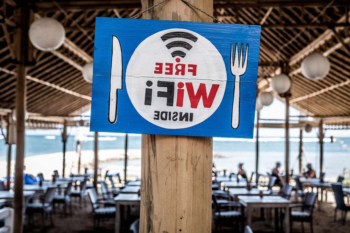 indonesia Free WiFi signage on wooden post bench